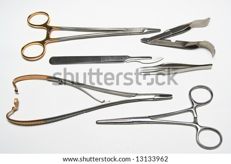 Various medical/surgical instruments: Clamps, needle holder, suture remover, tweezers, scalpel