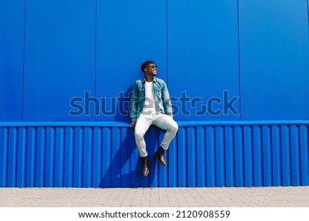 Similar – Image, Stock Photo Urban portrait of a girl with her eyes lowered because of the bright sun. A nice girl outdoors against the background of a fountain in a summer evening.