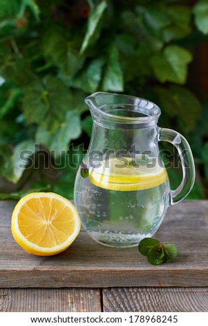 Cold lemon water with  mint in a glass jug