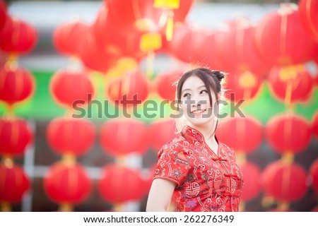 asian beautiful girl in chinese traditional red dress smile in chinese lantern background