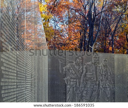 Washington DC - Vietnam Veteran\'s Memorial with image of three soldiers monument ghosted on the wall.