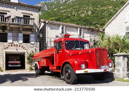 PERAST, MONTENEGRO - AUGUST 27. fire retro car on the waterfront town of Perast on 27 August. Old town in Montenegro. Located on the shores of Boka Bay of the Adriatic Sea