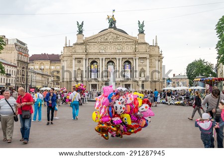 Lviv, Ukraine - June 2015:  The seller of balloons in the center of the square at the fountain near the Lviv Opera House