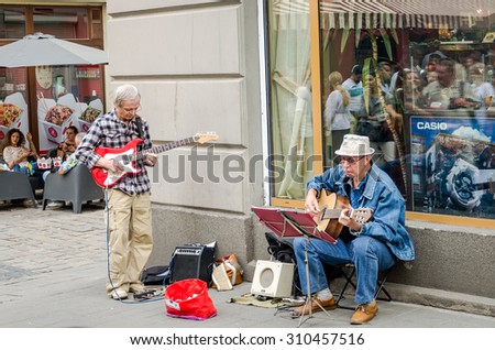 Lviv, Ukraine - August 2015: The old street musician playing guitar on the old streets of Lviv