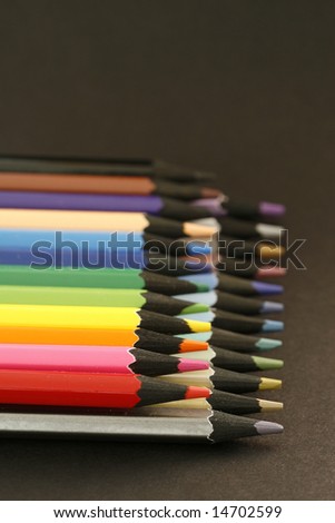 colors pencils in a simple black color background