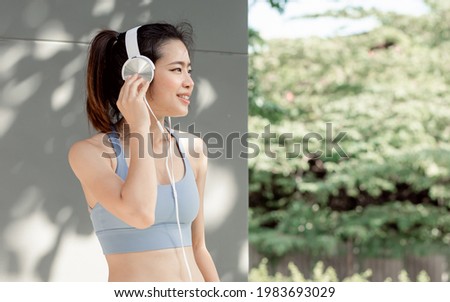 Similar – Image, Stock Photo Sportive woman in headphones using social media on smartphone