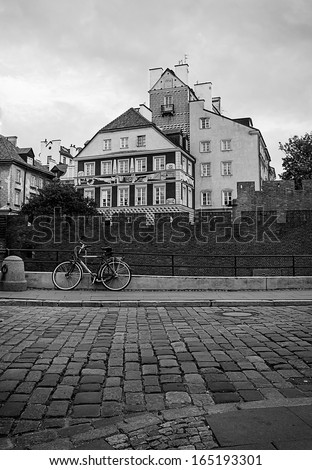 bike on the block pavements on the background of medieval houses in Warsaw Black and white