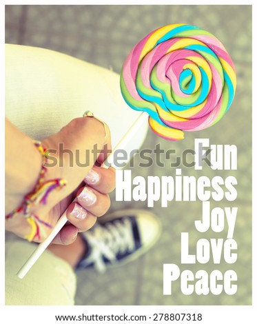 Fun Happiness Joy love Peace / Female hand holding colorful spiral lollipop