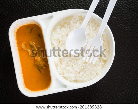 Takeaway rice and curry in a meal box.