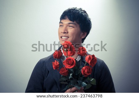 Asian guy with red roses in retro style