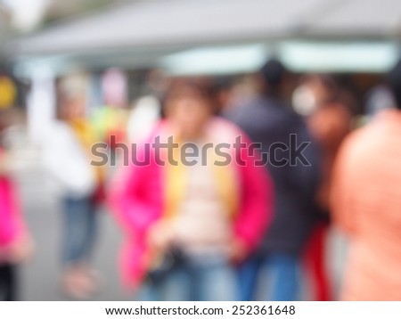 out of focus picture of a crowd of people walking in the city