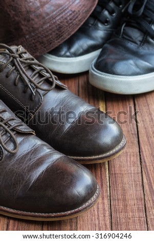 Leather shoes and hat on wooden background
