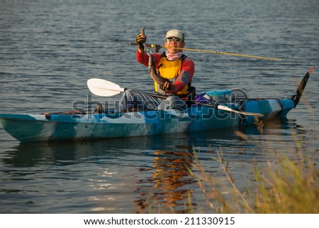 finish fishing on the kayak at reservoir by fisherman