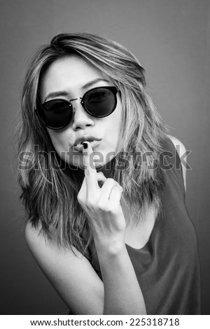 black and white picture of bad girl showing middle finger