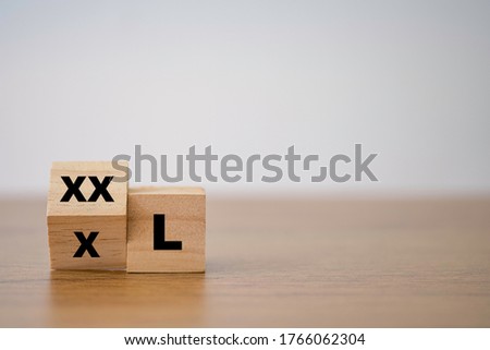 Flipping wooden cubes block which print screen XL to XXL. Increase or expand size of shirt or pant concept. Photo stock © 