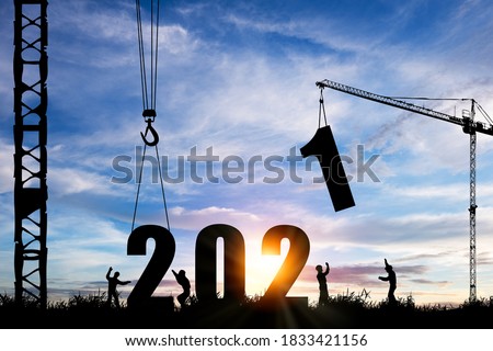 Silhouette of construction worker with crane under prepare welcome 2021 new year party and change new business.
