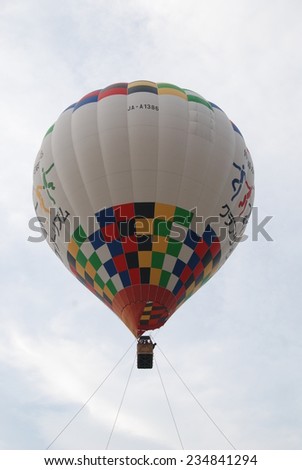 MATSUMOTO, JAPAN - JULY 22, 2014: a hot-air balloon rising in the sky. The hot air balloon is the oldest human flight technology.