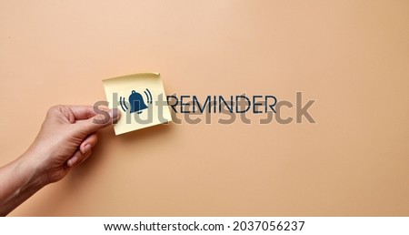 A sticker with drawings of a bell and the inscription: "Reminder". Reminder symbol
