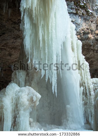 Ice Mountain of icicles on a background of the cave