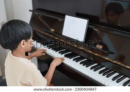 Similar – Image, Stock Photo Smiling child playing piano in cozy room in daylight