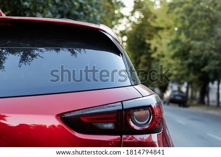 Back window of red car parked on the street in summer sunny day, rear view. Mock-up for sticker or decals Stockfoto © 