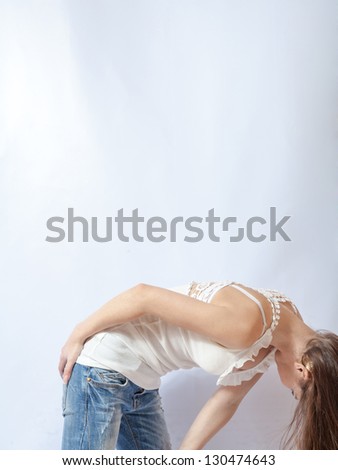 Pretty 20-24 years old blonde girl looking down on white background