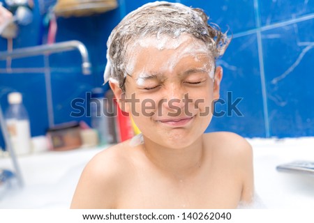 Cute three year old boy taking a bath with foam. Cute three year old boy taking a bath with foam closed eyes