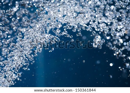 blue splash of waterdrops  close up shoot. Water fly levitate in the air with copyspace