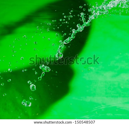 Levitating water drops. Water drops soaring in the air on the green background