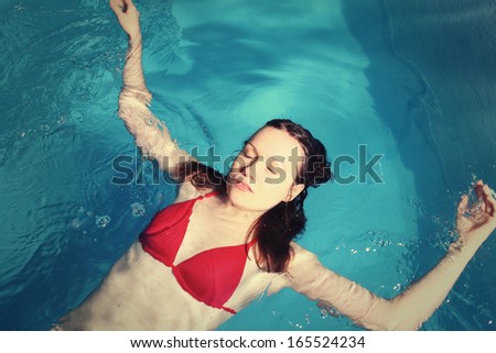 Young Red Bikini Female In Swimming in Pool