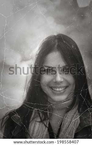 Smiling face of pretty brunette retro photo stylization.
