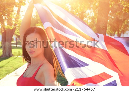 British girl holding the Jack Union flag in her hands