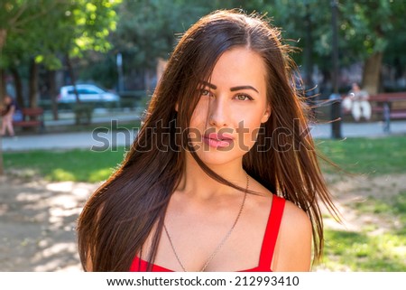 Young brunette women outdoors blank expression on her pretty face