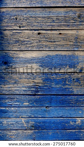 Old weathered planks painted in blue. Part of the background keep bright blue paint but other side is with no paint, we can see bare wood texture. A lot of copyspace, place for inscription.
