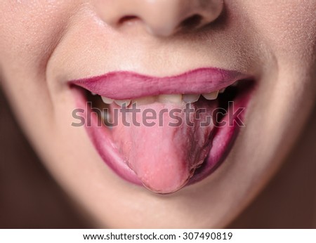Tongue out lips with makeup image