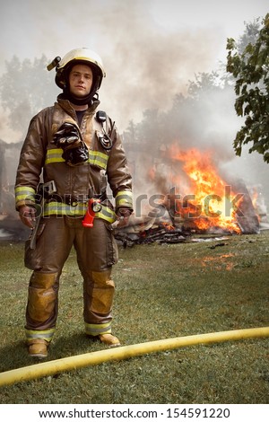 Real People - Firefighter Portrait with house on fire in background