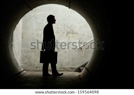 Side view of a Businessman looking in front of him in a tunnel. With room for your text