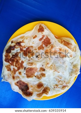 Roti Canai is a popular breakfast n dinner dish in Asia. Stock fotó © 