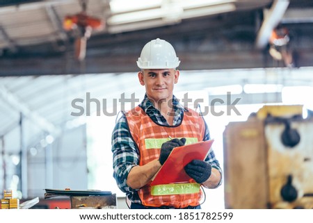 Portrait of engineer foreman in hardhat working on construction repair checklist document clipboard in industrial manufacturing factory. worker man in protective uniform work hard. copy space Photo stock © 