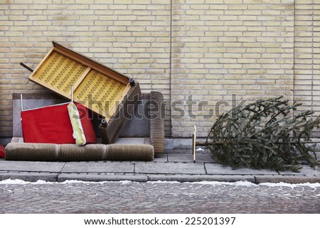 Broken furniture and Christmas tree left on pavement