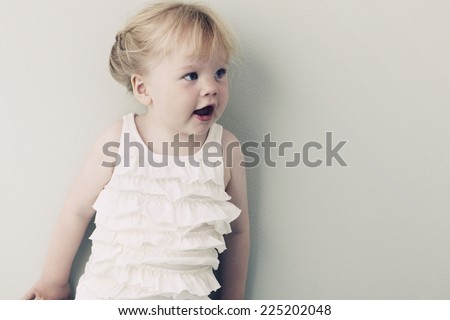 Babygro hanging on washing line against wooden background