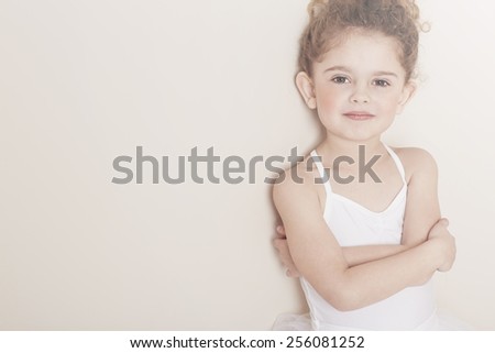Young girl with arms folded in studio, portrait