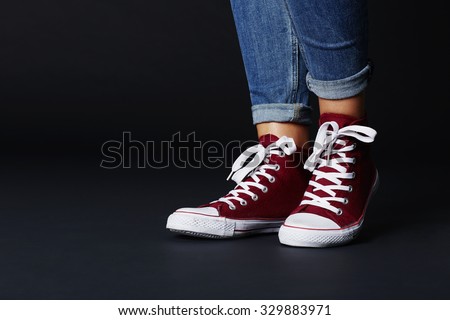 Close up low section of woman in red sneakers
