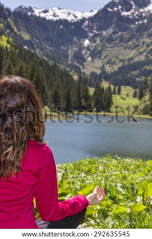 Woman in prayers pose outdoor in nature
