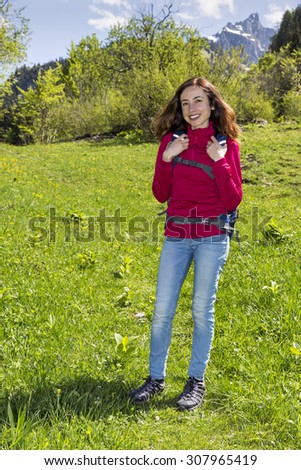 Hiker woman in front of mountains in spring