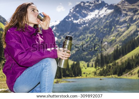 Woman drinking water during hiking