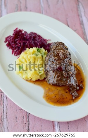 Beef roulade with mashed potato and red cabbage