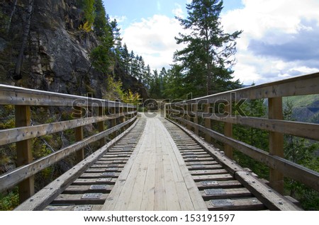 Historic Trestle Bridge. Myra Canyon in British Columbia, Myra Canyon is a popular tourist attraction featuring a cycling and hiking trail following the historical route of the Kettle Valley Railway.