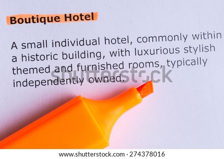 boutique hotel word highlighted on the white paper