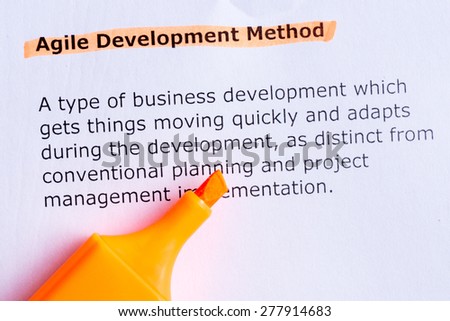 agile development method  word highlighted  on the white paper